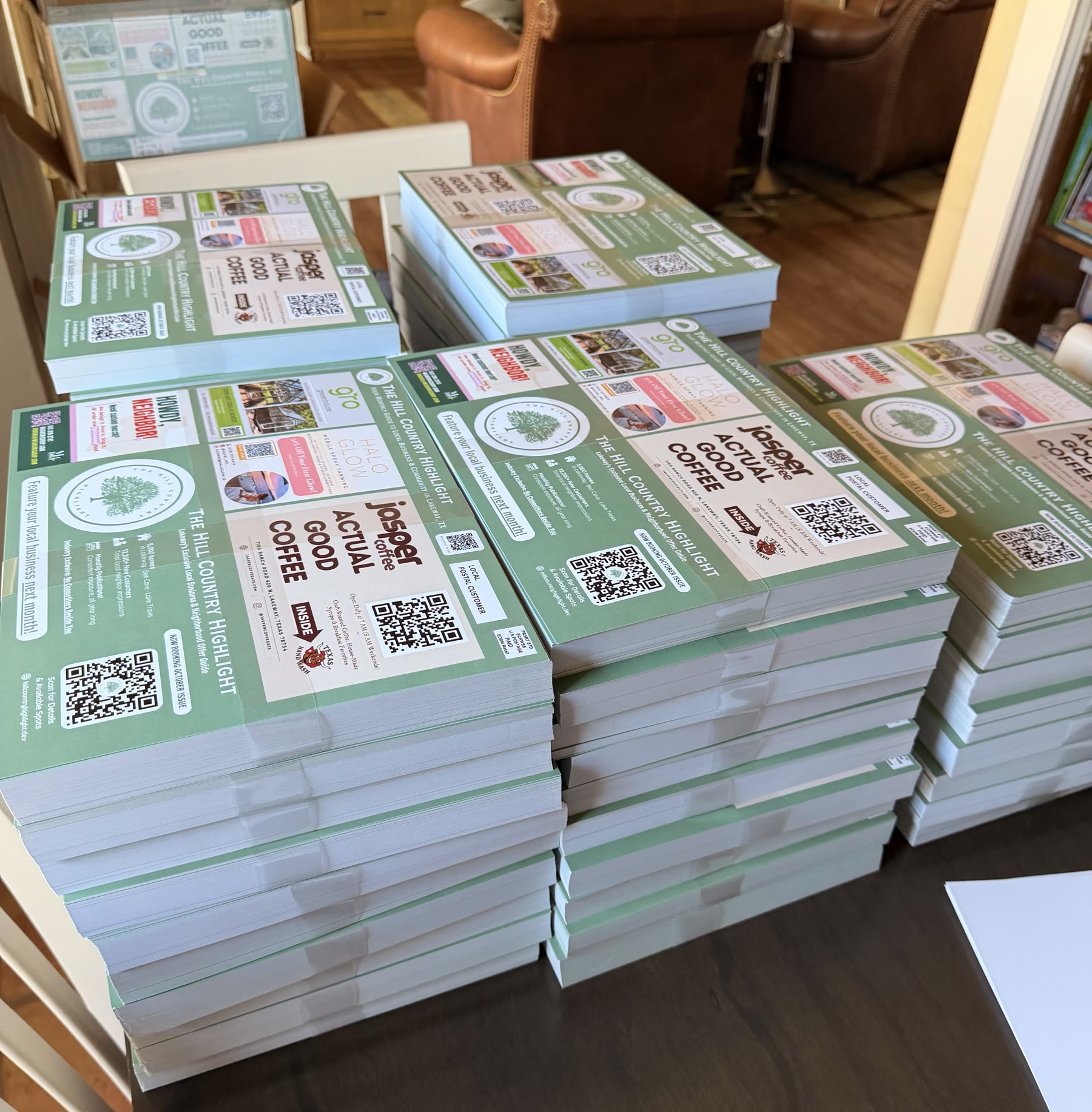 Stacks of printed Hill Country Highlight mailer cards ready for delivery